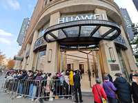 Customers line up outside Huawei's global flagship store to attend Huawei's Mate brand launch ceremony in Shanghai, China, on November 26, 2...