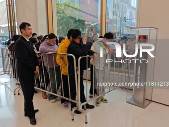 Customers line up outside Huawei's global flagship store to attend Huawei's Mate brand launch ceremony in Shanghai, China, on November 26, 2...