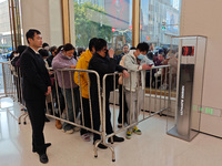 Customers line up outside Huawei's global flagship store to attend Huawei's Mate brand launch ceremony in Shanghai, China, on November 26, 2...