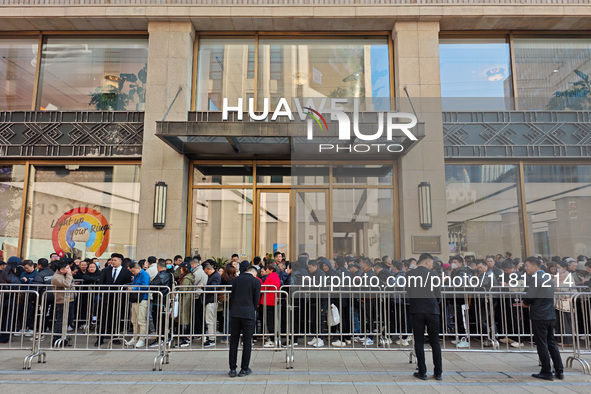 Customers line up outside Huawei's global flagship store to attend Huawei's Mate brand launch ceremony in Shanghai, China, on November 26, 2...