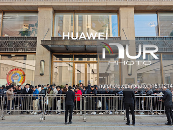 Customers line up outside Huawei's global flagship store to attend Huawei's Mate brand launch ceremony in Shanghai, China, on November 26, 2...