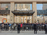 Customers line up outside Huawei's global flagship store to attend Huawei's Mate brand launch ceremony in Shanghai, China, on November 26, 2...