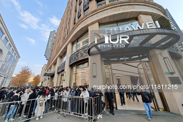 Customers line up outside Huawei's global flagship store to attend Huawei's Mate brand launch ceremony in Shanghai, China, on November 26, 2...