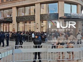 Customers line up outside Huawei's global flagship store to attend Huawei's Mate brand launch ceremony in Shanghai, China, on November 26, 2...