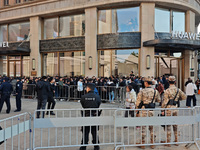 Customers line up outside Huawei's global flagship store to attend Huawei's Mate brand launch ceremony in Shanghai, China, on November 26, 2...