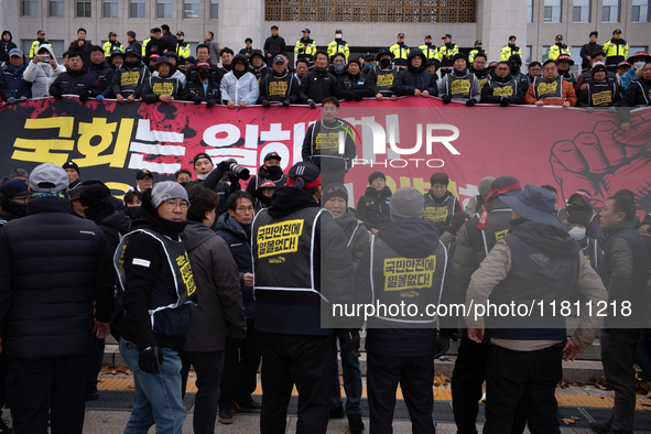 Over 100 members of the Cargo Truckers' Solidarity Division under the Korean Confederation of Trade Unions Public Transport Workers' Union s...