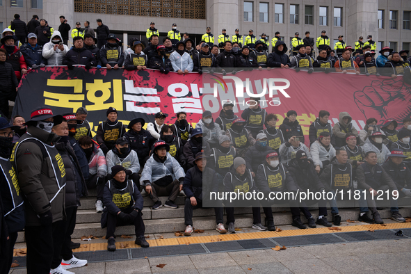 Over 100 members of the Cargo Truckers' Solidarity Division under the Korean Confederation of Trade Unions Public Transport Workers' Union s...