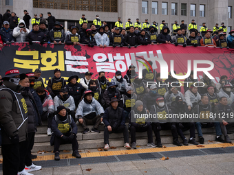 Over 100 members of the Cargo Truckers' Solidarity Division under the Korean Confederation of Trade Unions Public Transport Workers' Union s...