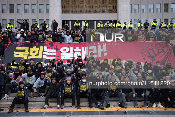 Over 100 members of the Cargo Truckers' Solidarity Division under the Korean Confederation of Trade Unions Public Transport Workers' Union s...