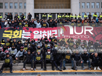 Over 100 members of the Cargo Truckers' Solidarity Division under the Korean Confederation of Trade Unions Public Transport Workers' Union s...