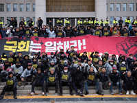 Over 100 members of the Cargo Truckers' Solidarity Division under the Korean Confederation of Trade Unions Public Transport Workers' Union s...