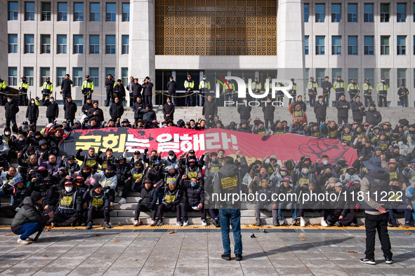 Over 100 members of the Cargo Truckers' Solidarity Division under the Korean Confederation of Trade Unions Public Transport Workers' Union s...