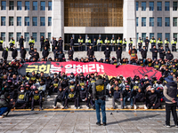 Over 100 members of the Cargo Truckers' Solidarity Division under the Korean Confederation of Trade Unions Public Transport Workers' Union s...