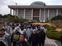 Over 100 members of the Cargo Truckers' Solidarity Division under the Korean Confederation of Trade Unions Public Transport Workers' Union l...