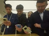 Customers experience the newly released Mate70 series mobile phone at a Huawei store in Hangzhou, Zhejiang province, China, on November 26,...