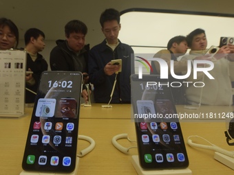 Customers experience the newly released Mate70 series mobile phone at a Huawei store in Hangzhou, Zhejiang province, China, on November 26,...