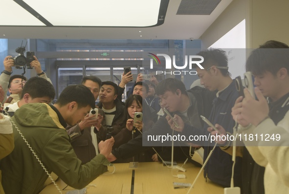 Customers experience the newly released Mate70 series mobile phone at a Huawei store in Hangzhou, Zhejiang province, China, on November 26,...