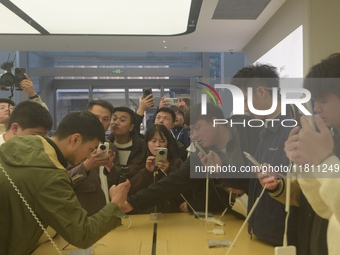 Customers experience the newly released Mate70 series mobile phone at a Huawei store in Hangzhou, Zhejiang province, China, on November 26,...