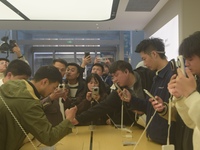 Customers experience the newly released Mate70 series mobile phone at a Huawei store in Hangzhou, Zhejiang province, China, on November 26,...