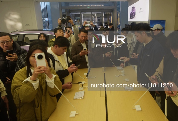 Customers experience the newly released Mate70 series mobile phone at a Huawei store in Hangzhou, Zhejiang province, China, on November 26,...