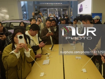 Customers experience the newly released Mate70 series mobile phone at a Huawei store in Hangzhou, Zhejiang province, China, on November 26,...