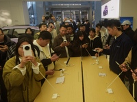 Customers experience the newly released Mate70 series mobile phone at a Huawei store in Hangzhou, Zhejiang province, China, on November 26,...