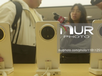 Customers experience the newly released Mate70 series mobile phone at a Huawei store in Hangzhou, Zhejiang province, China, on November 26,...