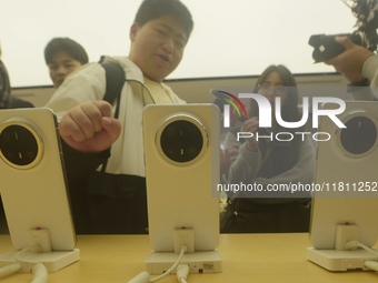 Customers experience the newly released Mate70 series mobile phone at a Huawei store in Hangzhou, Zhejiang province, China, on November 26,...