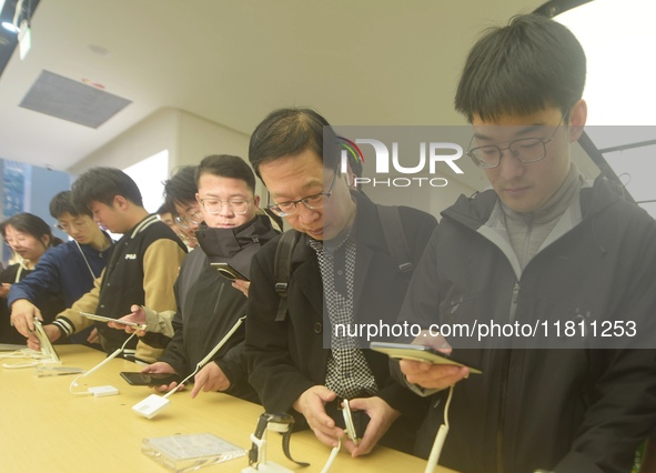 Customers experience the newly released Mate70 series mobile phone at a Huawei store in Hangzhou, Zhejiang province, China, on November 26,...