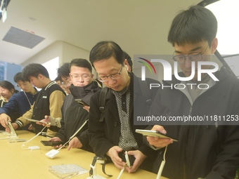 Customers experience the newly released Mate70 series mobile phone at a Huawei store in Hangzhou, Zhejiang province, China, on November 26,...