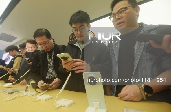 Customers experience the newly released Mate70 series mobile phone at a Huawei store in Hangzhou, Zhejiang province, China, on November 26,...