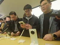 Customers experience the newly released Mate70 series mobile phone at a Huawei store in Hangzhou, Zhejiang province, China, on November 26,...