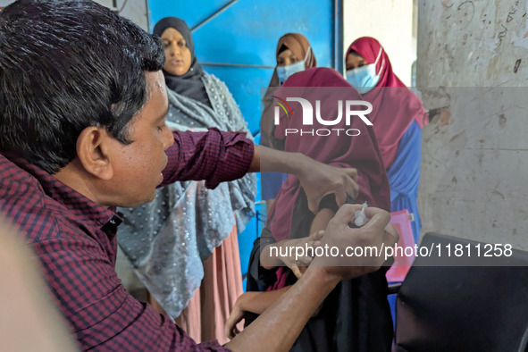 A madrasah student receives the HPV vaccine from a healthcare assistant in Feni, Bangladesh, on November 26, 2024. Bangladesh takes strides...