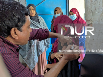 A madrasah student receives the HPV vaccine from a healthcare assistant in Feni, Bangladesh, on November 26, 2024. Bangladesh takes strides...