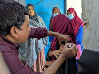 A madrasah student receives the HPV vaccine from a healthcare assistant in Feni, Bangladesh, on November 26, 2024. Bangladesh takes strides...