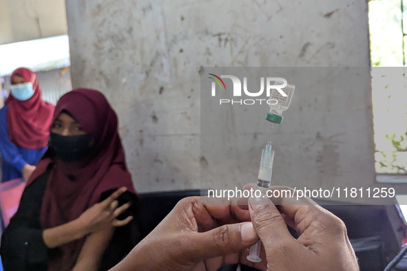 A madrasah student receives the HPV vaccine from a healthcare assistant in Feni, Bangladesh, on November 26, 2024. Bangladesh takes strides...