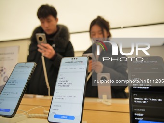 Customers learn about the newly released Huawei Mate70 series mobile phone at a Huawei store in Yantai, China, on November 26, 2024. (