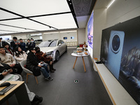 Customers watch the Mate70 new phone launch event at a Huawei store in Nanjing, China, on November 26, 2024. (