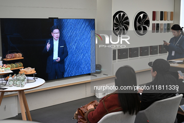 Customers watch the Mate70 new phone launch event at a Huawei store in Nanjing, China, on November 26, 2024. 