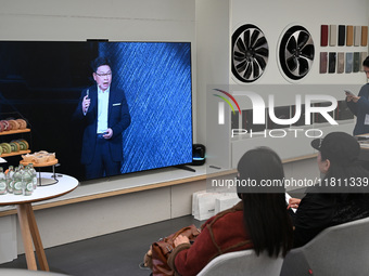 Customers watch the Mate70 new phone launch event at a Huawei store in Nanjing, China, on November 26, 2024. (