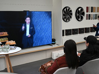 Customers watch the Mate70 new phone launch event at a Huawei store in Nanjing, China, on November 26, 2024. (