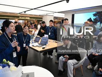 A Huawei employee displays the Mate70 phone in Nanjing, China, on November 26, 2024. (