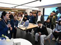 A Huawei employee displays the Mate70 phone in Nanjing, China, on November 26, 2024. (