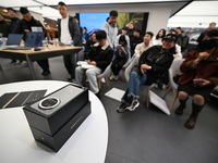 Customers experience the newly released Huawei Mate70 phone at a Huawei store in Nanjing, China, on November 26, 2024. (