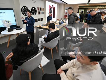 Customers experience the newly released Huawei Mate70 phone at a Huawei store in Nanjing, China, on November 26, 2024. (