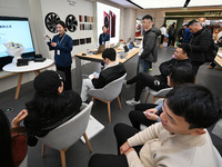 Customers experience the newly released Huawei Mate70 phone at a Huawei store in Nanjing, China, on November 26, 2024. (