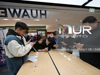 Customers experience the newly released Huawei Mate70 phone at a Huawei store in Nanjing, China, on November 26, 2024. (