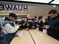 Customers experience the newly released Huawei Mate70 phone at a Huawei store in Nanjing, China, on November 26, 2024. (