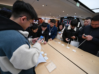 Customers experience the newly released Huawei Mate70 phone at a Huawei store in Nanjing, China, on November 26, 2024. (