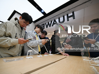 Customers experience the newly released Huawei Mate70 phone at a Huawei store in Nanjing, China, on November 26, 2024. (